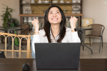Beautiful young businesswoman expresses happiness for business success.Excited happy Asian woman...