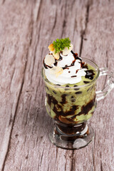 Green tea ice cream in glass cup.Collection of different desserts.Gourmet summer dessert of artisanal or craft ice cream made.Cafe menu.