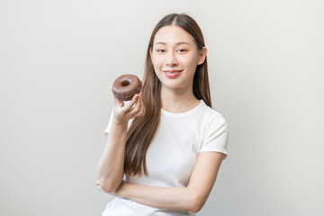 Portrait of pretty attractive asian young teenage woman holding chocolate, donut, doughnut, female...