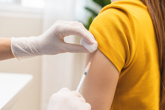 Health care, corona virus, hand of woman nurse, doctor giving syringe vaccine, injection dose on arm sick patient at clinic. Vaccination, immunization disease prevention against flu pandemic influenza