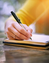 Woman, hand and pen with paper for writing or planning, checklist on table for development goals....