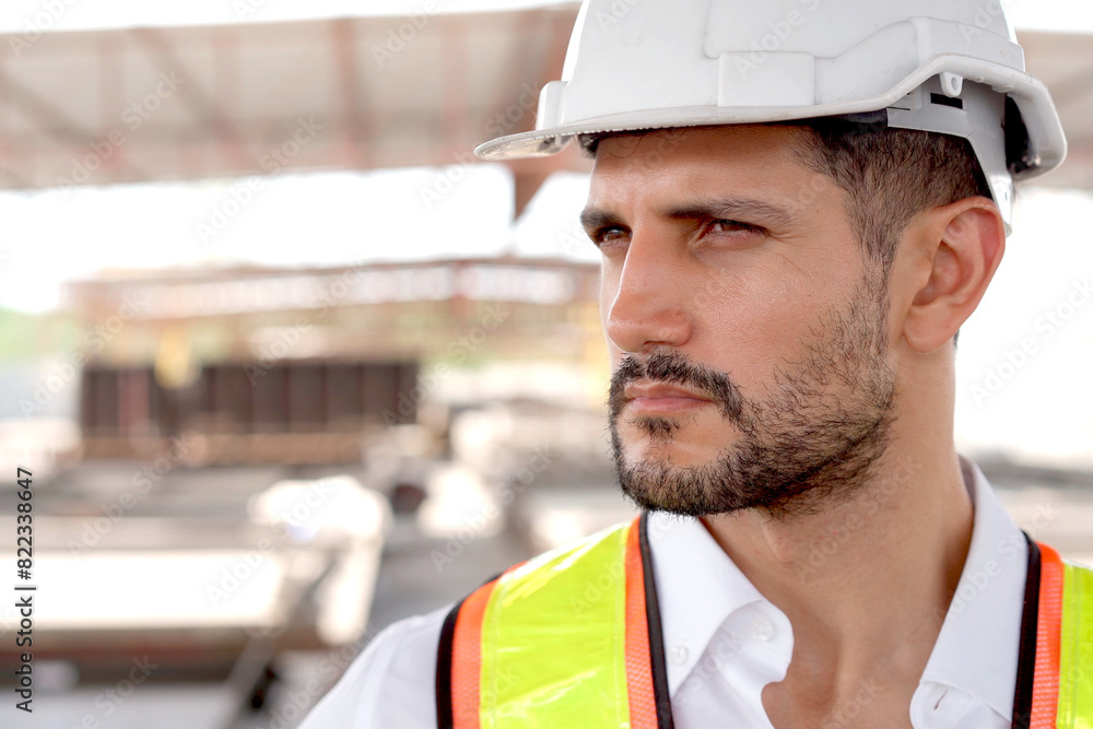 Wall mural hispanic male engineer working at construction site.