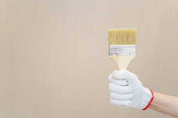 Woman painting the wall at home.