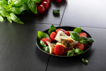 Mozzarella with basil, cherry tomatoes and pesto sauce sprinkled with Mediterranean spices.