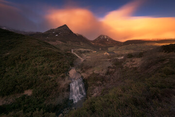 warm sunrise at the Pardo waterfall, in the mountain pass of Estacas de Trueba, Burgos, with a...