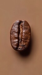 Close-up of a single coffee bean on a brown background, showcasing the texture and detail of this essential ingredient in coffee brewing.