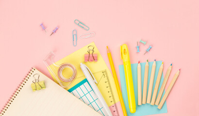 stationery items for girls or women on light pink background. Back to school. Female Student's, pupil's or engineer's supplies. Office objects on pastel pink background. Calculator, pen, pencil etc.