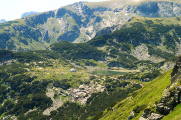 Naklejka premium View onto the Fish Lake, Ribnoto Ezero with the Seven Lakes Chalet right next to it at the Seven Rila Lakes Plateau, Rila National Park close to Sofia, Bulgaria