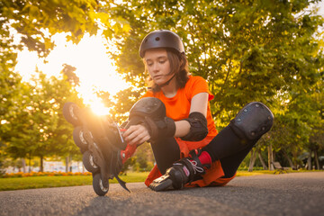 Roller skating girl kid in park rollerblading on inline skates.