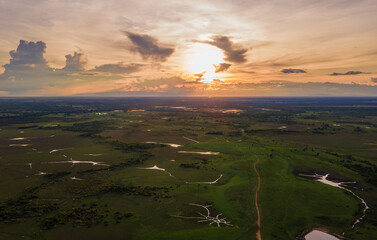 Aerial view of Hato La Aurora at sunset with vast plains and water bodies