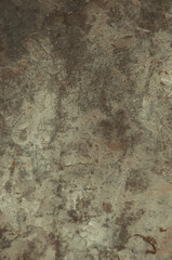 A wall with a lot of cracks and dirt on it