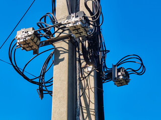 Concrete pillars with electrical wires, coils of cables and switching equipment. Electricity...