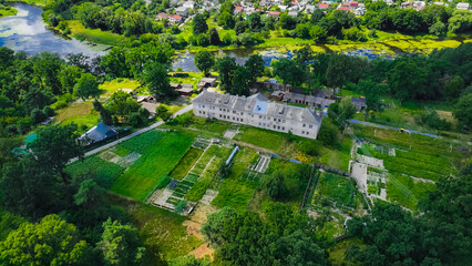 aerial landmark village urban view of summer outskirts with buildings trees and river, summer bright day time