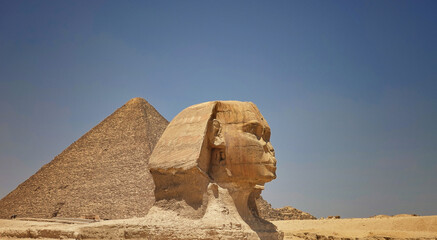 Sphinx and Pyramid of Giza in Egypt against a blue sky
