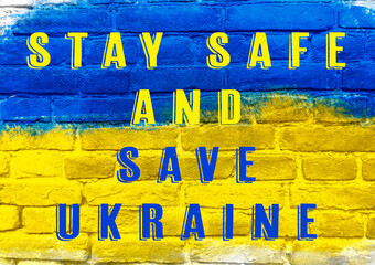 A blue and yellow sign that says Stay Safe and Save Ukraine
