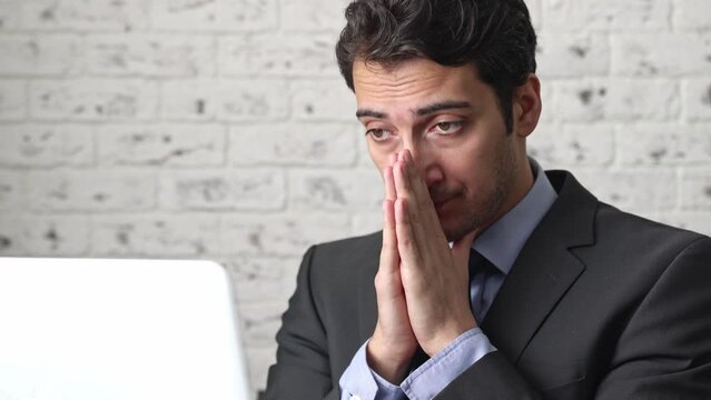 Tired frustrated and overworked business man sitting in the office and thinking about problems in business	