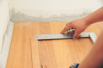 Construction Workers using ruler measure at construction site. Builder Hand with floor house...