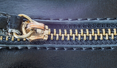 Zipper on a leather dark handbag up close