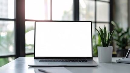 Fototapeta premium Laptop pc mock up template design on office workplace desk, white mockup empty blank computer screen on office work table business web technology at modern workspace, closeup