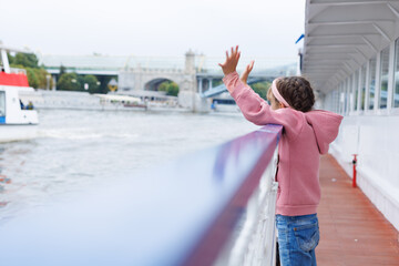 Girl greeting, say goodbye for ship cruise, international transport or travel. Side view girl in...
