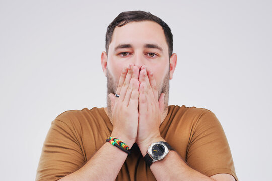 Studio portrait, man and shock for mistake with wow, gossip news and drama or secret announcement. Male person, surprised and oops emoji with hands for crisis and meme reaction by white background