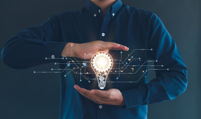 Idea innovation and inspiration concept.Hand of man holding illuminated light bulb, Idea innovation...