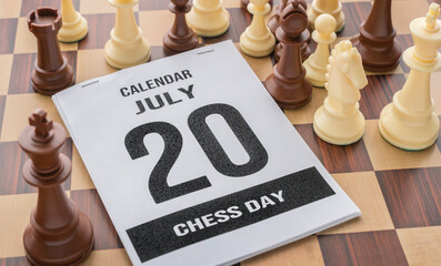 July 20th calendar sheet showing chess day. calendar and  chess game pieces  a chessboard
