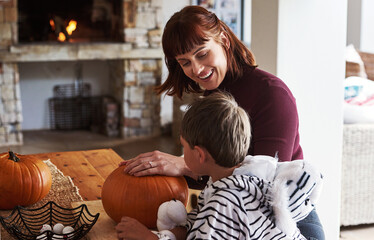 Happy family, mother and kid with pumpkin for halloween to celebrate with smile, son or boy for...