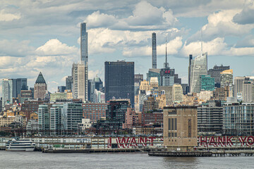 New York, NY, USA - August 1, 2023: slender Central Park and 111 West 57th street towers above sea...