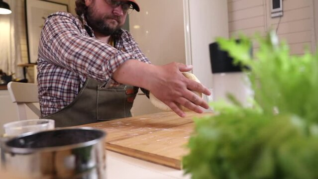 a male chef prepares the dough for making kutab