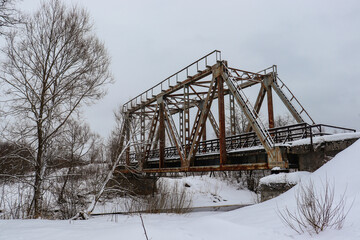 Old railway bridge in Gulbene, Latvia. Winter landscape, snow.