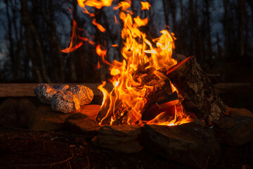 Big fire at night in the forest. Warm and summer in Norway