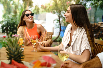 Friends Enjoying Drinks Outdoors - Relaxed and Joyful Moment