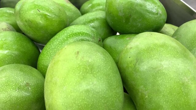 close up of green magoes for sale
