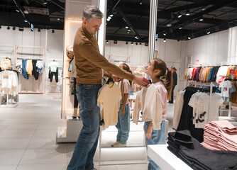 Father and Daughter Shopping Together at a Clothing Store in the Evening