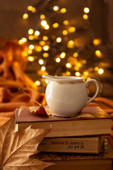 books, leaves, coffee cup and bokeh lights
