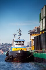 4K Ultra HD Image: Tug Boat Maneuvering Cargo Ship at Dockside in Port of Long Beach