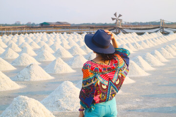 Woman enjoying an ecotravel to a sprawling salt pan in Samut Sakhon province, Thailand