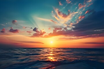 Fototapeta premium A stunning sunset over the ocean with fluffy clouds reflecting on the water.