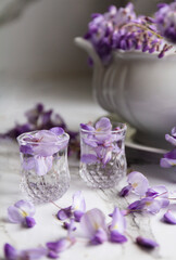 glasses with water and purple flower called lilac flowers
