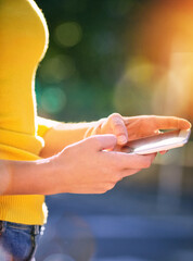 Outdoor, hands or person with mobile for typing, chat and browsing online on social media. Bokeh, smartphone and girl scrolling with internet, technology and connection for networking with contact