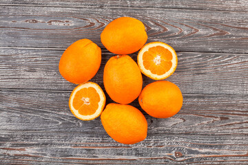 sliced calabrian oval blond oranges on wood background top view