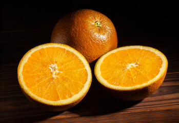 sliced chocolate oranges on wood background