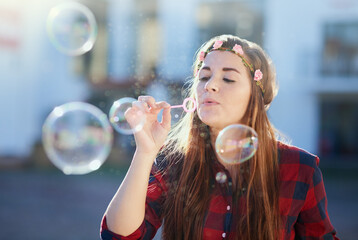 Woman, play and blowing bubbles in street with fun in summer sunshine for memory with soap fluid....