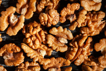 walnuts on black wood background top view