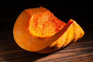 sliced pumpkin on wood background