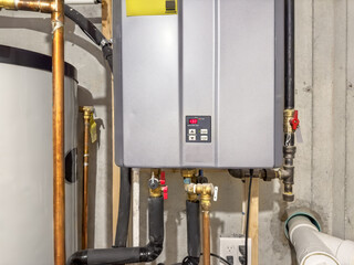 Tankless hot water heater, set to 130° F,  connected to a recirculation system and storage tank