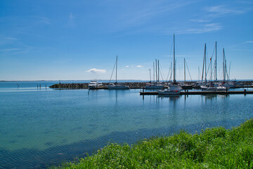 Port with sailboats and quiet water, with blue sky