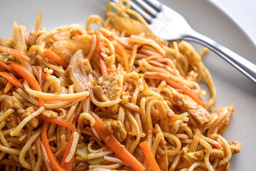 Chicken chow mein. Traditional Chinese food. Stir fry noodles with chicken, carrot, onion and cabbage.