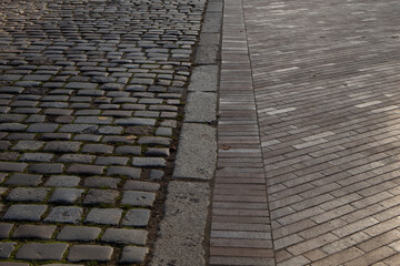 The pavement area is paved with gray large stones and tiles texture